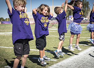 Preschool students jump and dance at assembly